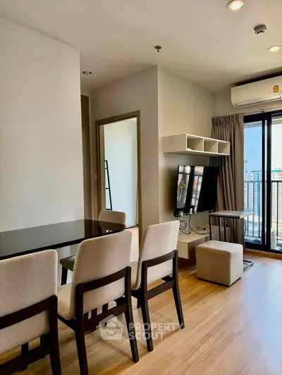 Modern living room with dining area and city view balcony in a stylish apartment.