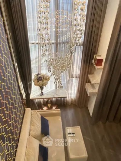 Luxurious living room with high ceiling and elegant chandelier in modern apartment