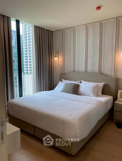 Luxurious bedroom with modern decor and city view in high-rise apartment