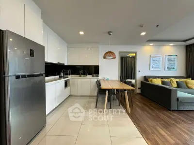 Modern open-plan kitchen and living room with sleek design and stylish furniture.