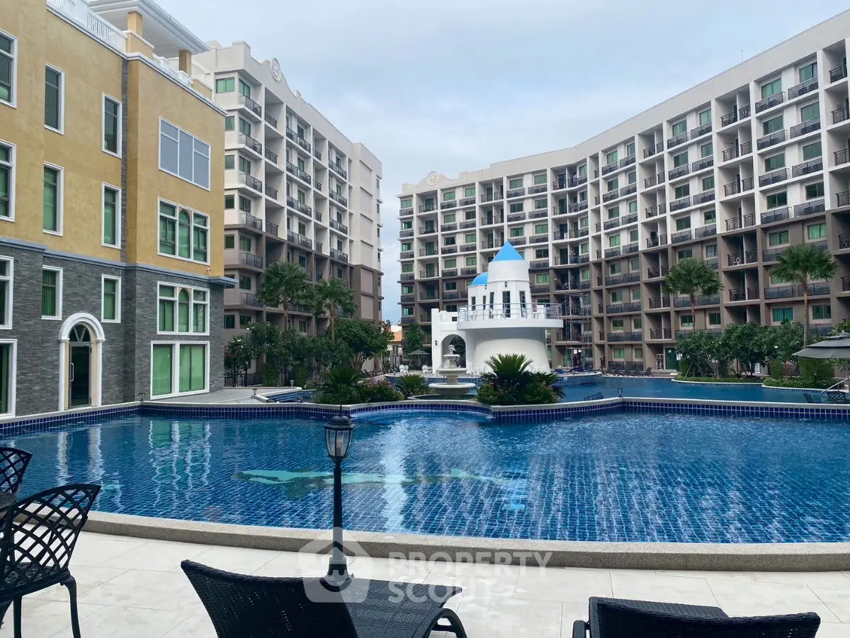 Luxurious apartment complex with stunning pool and Mediterranean architecture.