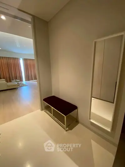 Spacious modern living area with stylish bench and full-length mirror