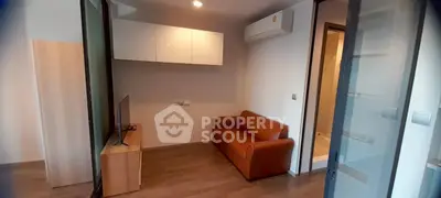 Modern living room with sleek design, featuring a cozy sofa and mounted TV, perfect for urban living.