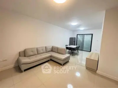 Spacious modern living room with sleek furniture and dining area in open layout