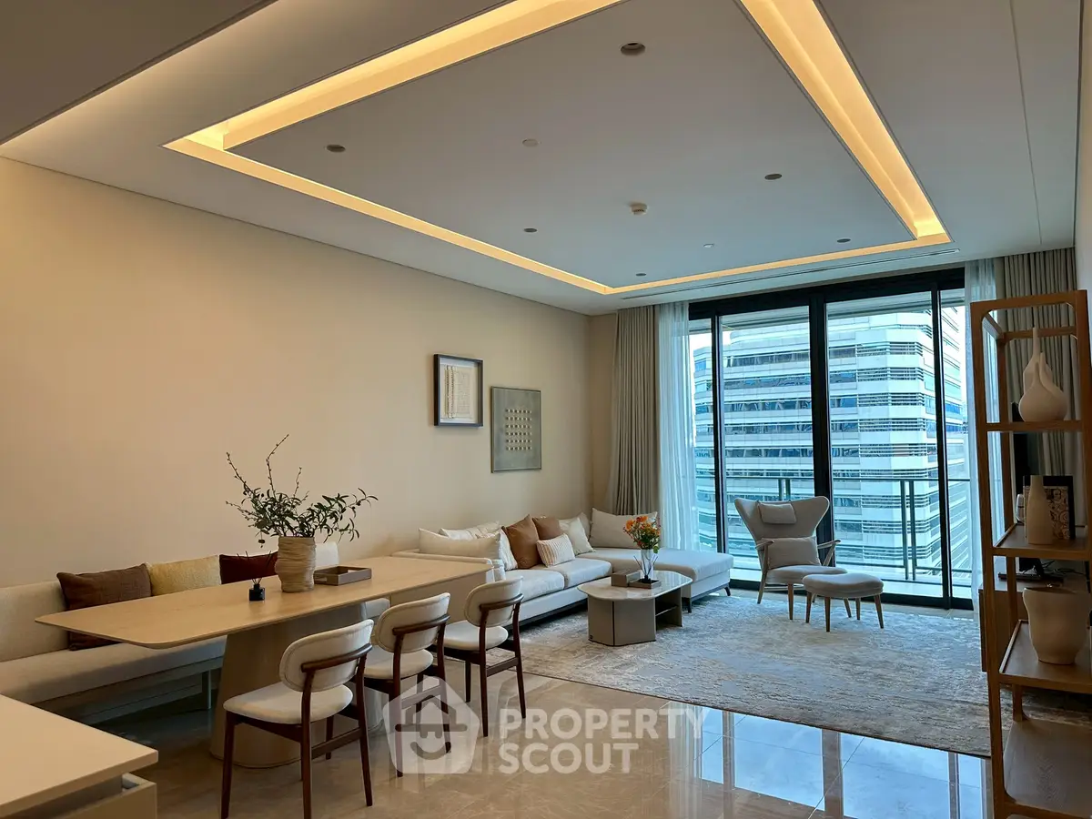 Luxurious modern living room with elegant decor and city view balcony.