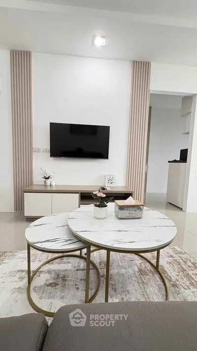 Modern living room with stylish decor and marble coffee tables, perfect for contemporary living.