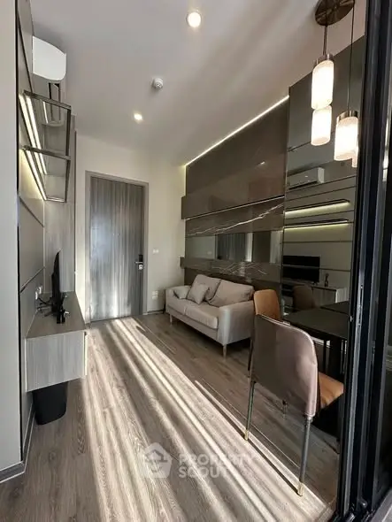 Modern living room with sleek design and natural light, featuring a cozy sofa and stylish decor.