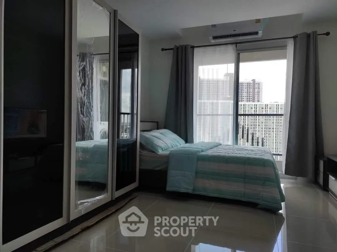 Modern bedroom with city view and large wardrobe in high-rise apartment