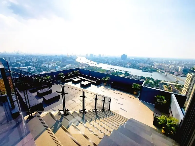 Stunning rooftop terrace with panoramic city and river views, perfect for relaxation and entertainment.