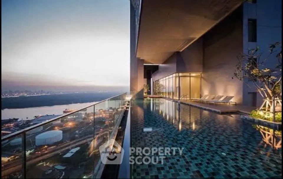 Luxurious rooftop infinity pool with stunning city and river views at sunset.