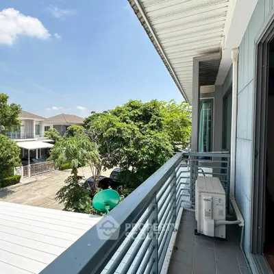 Charming balcony view with lush greenery in a modern residential area.