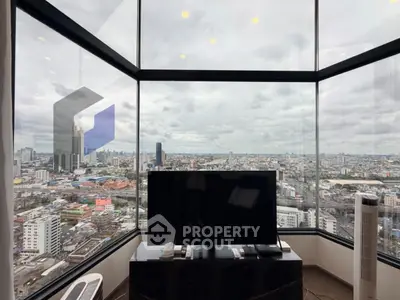 Stunning panoramic city view from modern high-rise apartment living room.
