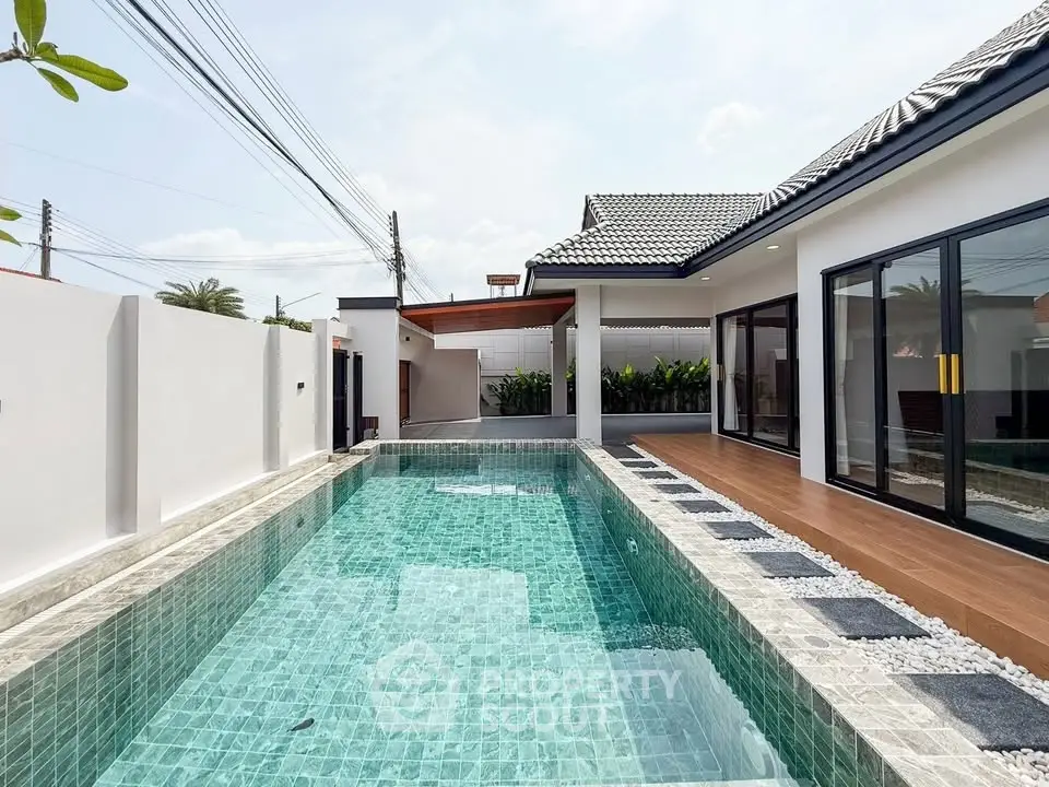 Luxurious modern home with private pool and elegant patio area.