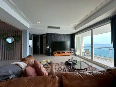 Luxurious living room with stunning ocean view and spacious balcony in modern apartment.