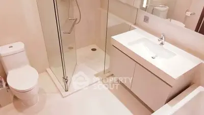 Modern bathroom with sleek fixtures and glass shower enclosure