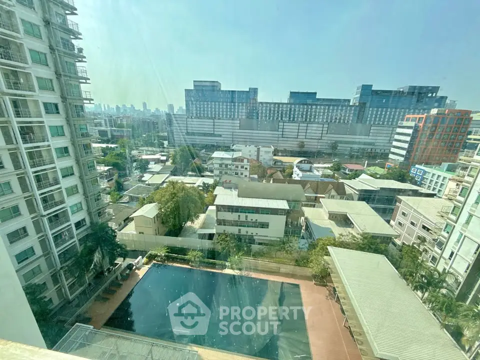 Stunning cityscape view with pool from high-rise building, perfect for urban living.