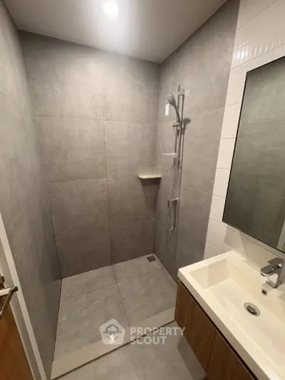 Modern bathroom with sleek shower and stylish sink in contemporary design.