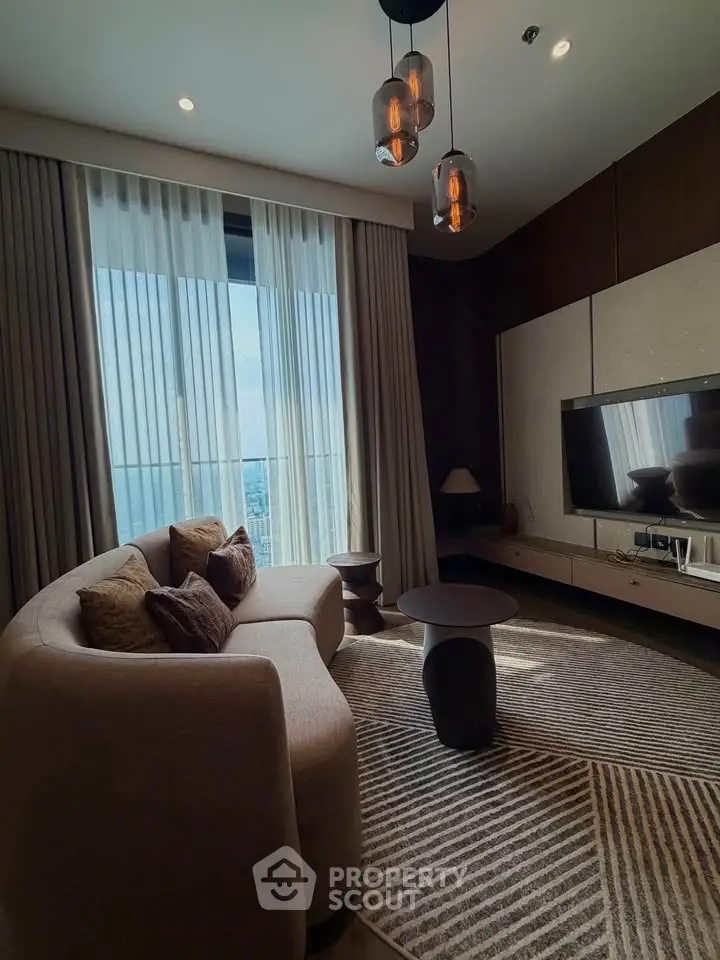 Luxurious living room with modern decor and stunning city view through large windows.