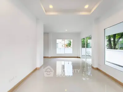 Spacious modern interior with large windows and glossy tiled floors