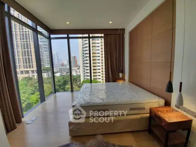 Luxurious bedroom with floor-to-ceiling windows offering stunning city views in a modern high-rise apartment.