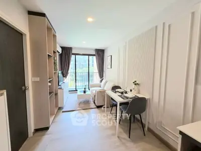 Modern living room with elegant decor and balcony view in a stylish apartment.