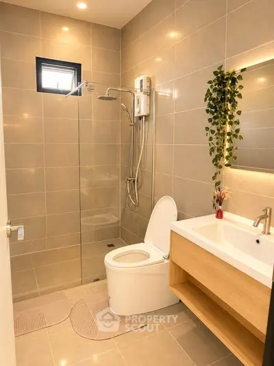 Modern bathroom with sleek fixtures and elegant lighting in a contemporary home.