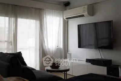 Modern living room with large TV and air conditioning