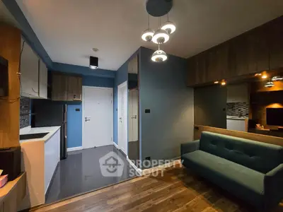 Modern living room with sleek design, blue accents, and stylish lighting in a contemporary apartment.
