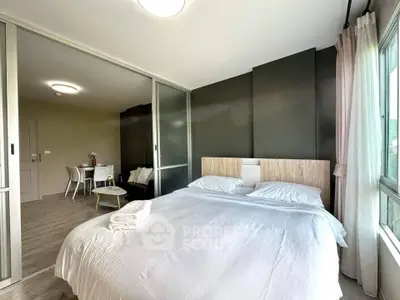 Modern bedroom with sliding glass doors and cozy decor