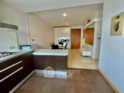 Modern open-layout kitchen with sleek cabinetry and dining area in a stylish apartment.