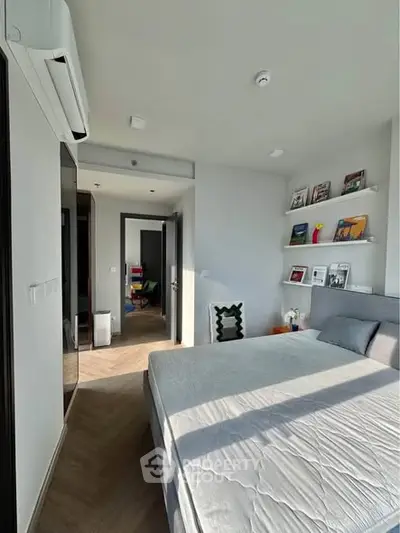 Modern bedroom with natural light, sleek design, and cozy atmosphere in a contemporary apartment.