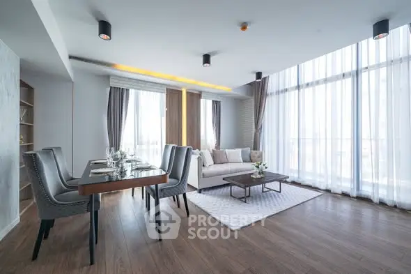 Spacious modern living room with elegant dining area and large windows.