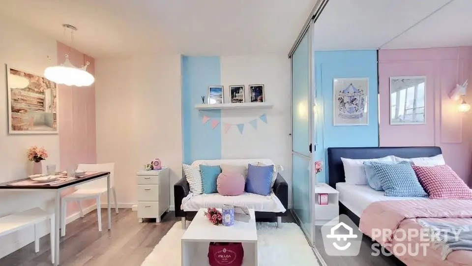 Charming pastel-themed studio apartment with cozy living and sleeping areas, perfect for modern urban living.