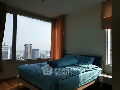 Spacious bedroom with city view and large windows in modern apartment