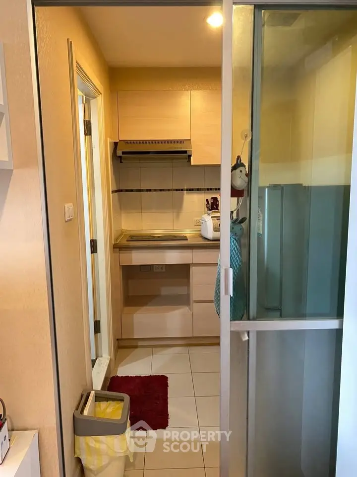 Compact kitchen with closed layout and modern appliances in cozy apartment