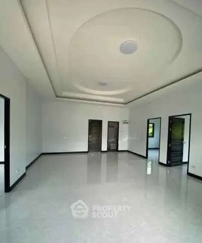 Spacious modern living room with elegant ceiling design and glossy flooring
