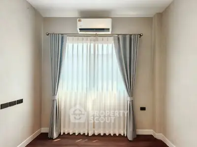 Bright room with elegant curtains and air conditioning, perfect for cozy living.