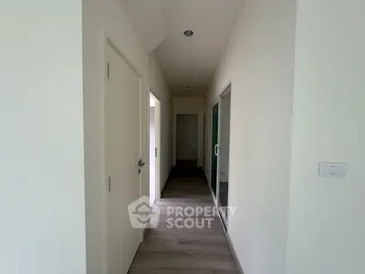 Modern hallway with sleek design and wooden flooring in a contemporary home