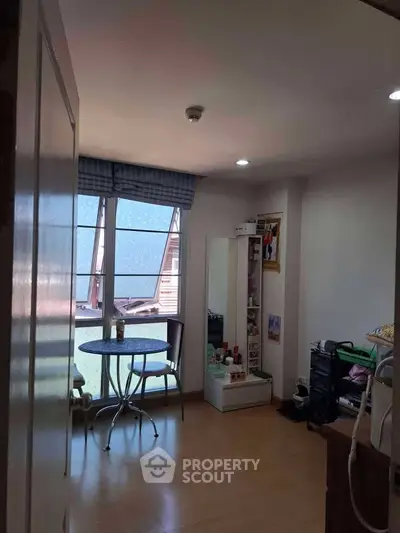 Cozy bedroom with natural light and compact furniture setup