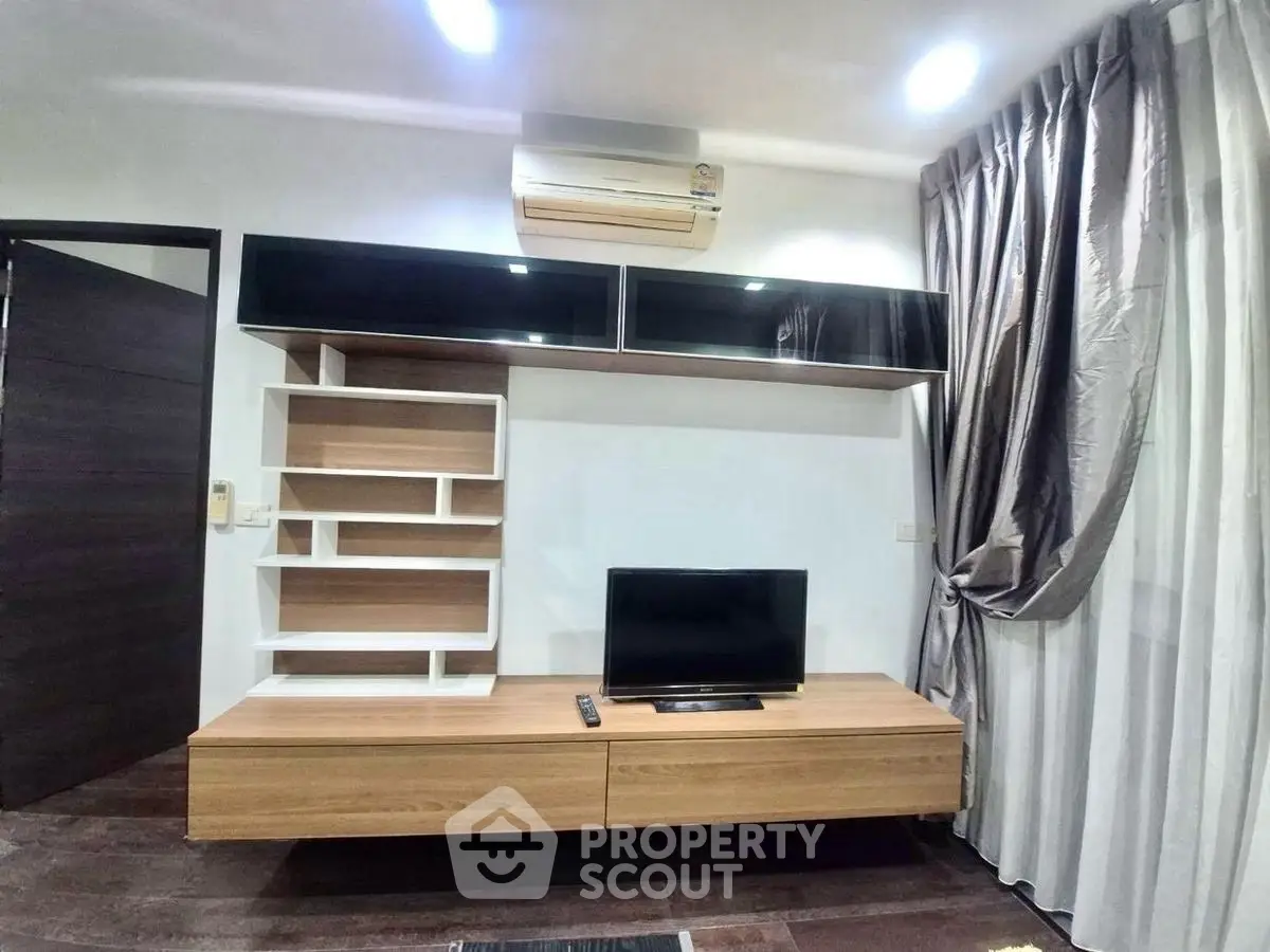 Modern living room with sleek TV unit and stylish shelving