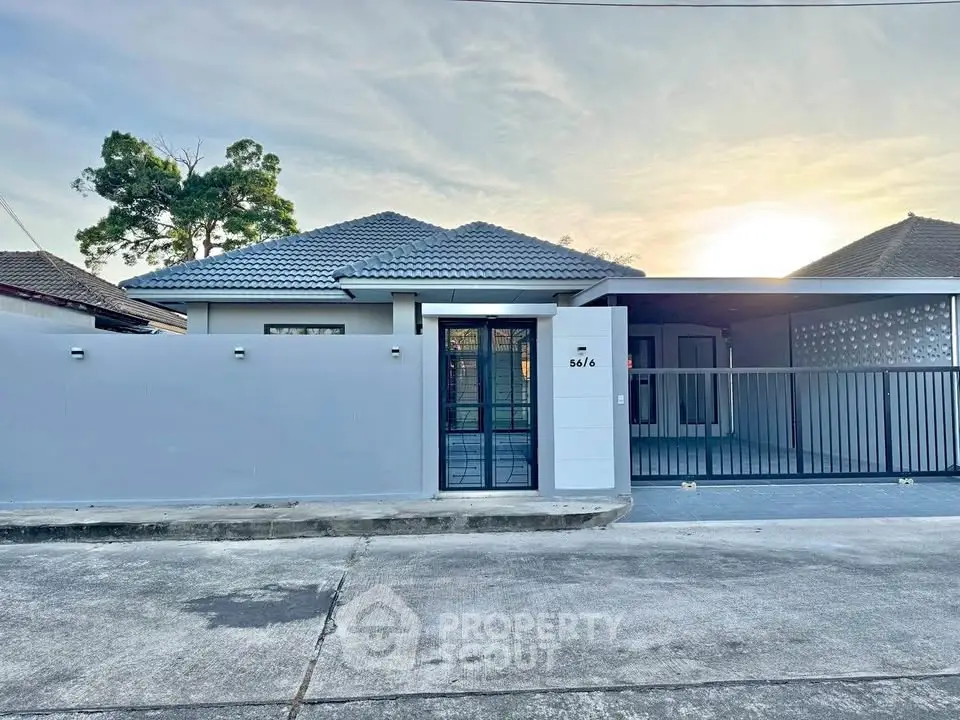 Charming single-story home with modern facade and gated driveway in a serene neighborhood.