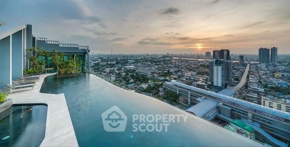 Stunning rooftop infinity pool with panoramic city views at sunset, perfect for luxury urban living.