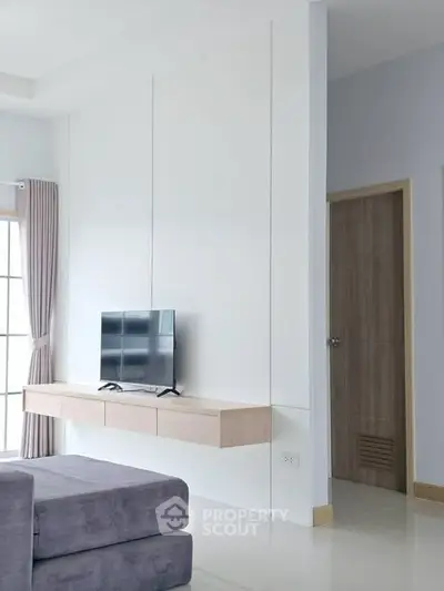 Modern living room with sleek TV setup and minimalist decor