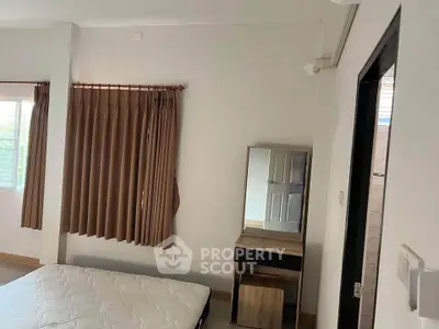 Cozy bedroom with natural light and modern furnishings, perfect for relaxation.