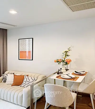 Modern living room with cozy sofa and elegant dining area, perfect for urban living.