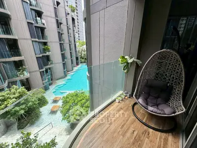 Luxurious balcony with pool view in modern apartment complex
