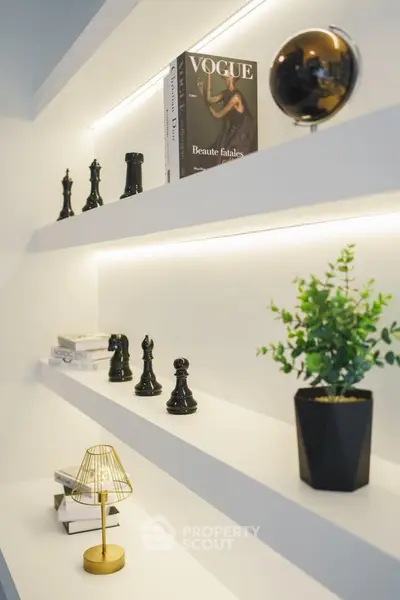 Modern interior with stylish shelving, decorative chess pieces, and ambient lighting.