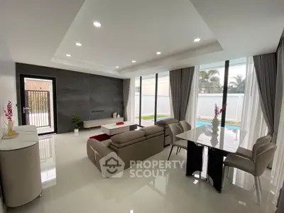 Spacious modern living room with pool view and elegant furnishings