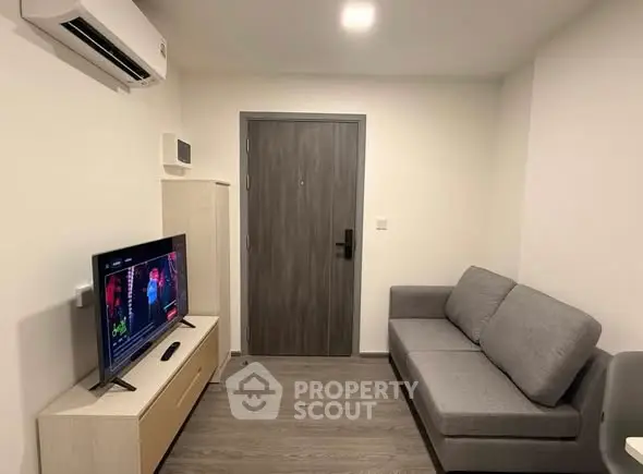 Modern living room with sleek furniture and wall-mounted TV, perfect for cozy relaxation.