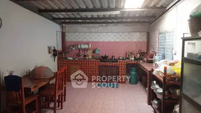 Charming rustic kitchen with open layout and gas stove, perfect for cozy family gatherings.